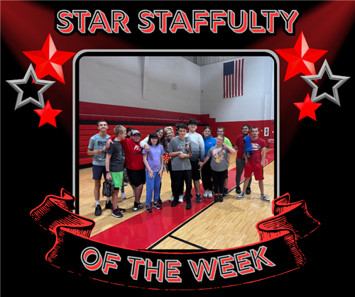 A group of students pose in the gym with Mrs. Drury and Mrs. Johnson.